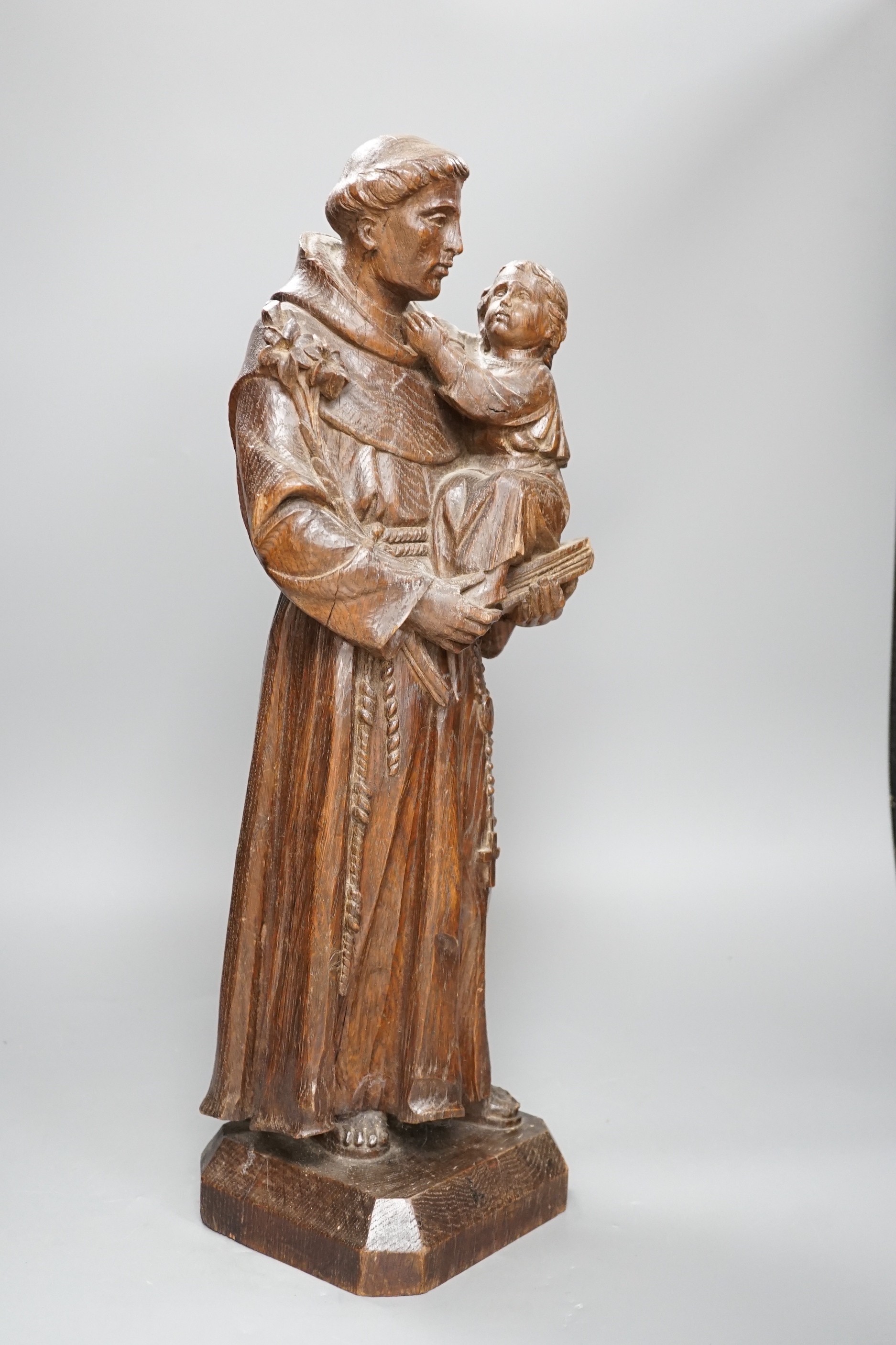 An early 20th century carved oak figure of St Anthony, 51cm